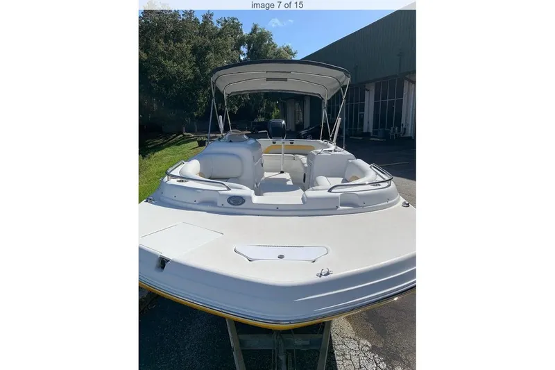 Slide: The Image of 2016 Hurricane SunDeck Sport 232 OB boat with canopy, docked outdoors. - 1