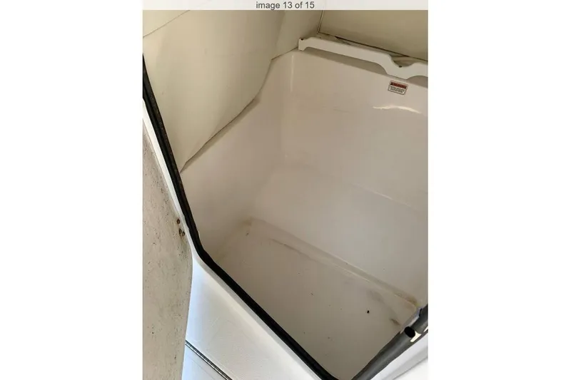 Slide: The Image of 2016 Hurricane SunDeck Sport 232 OB boat interior with seating and steering console. - 11