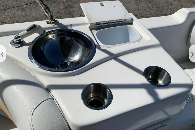 Slide: The Image of 2016 Hurricane SunDeck Sport 232 OB boat with canopy in storage. - 12