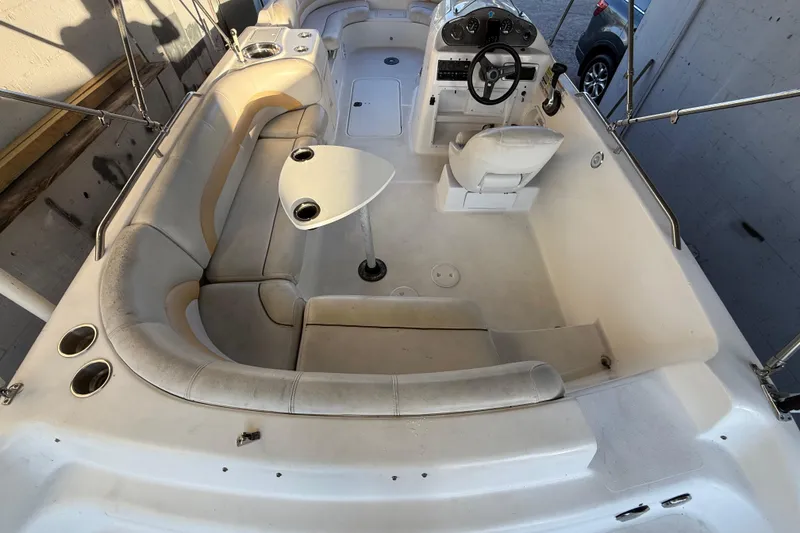 Slide: The Image of 2016 Hurricane SunDeck Sport 232 OB boat interior with seating and steering console. - 13