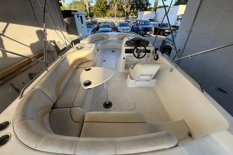 Slide: The Image of 2016 Hurricane SunDeck Sport 232 OB boat interior with seating and steering console. - 14