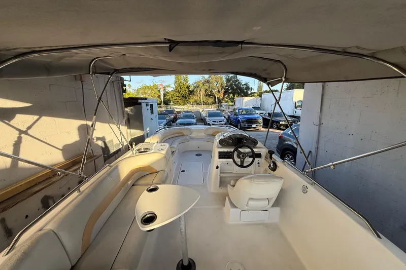 Slide: The Image of 2016 Hurricane SunDeck Sport 232 OB boat interior with canopy and seating. - 15