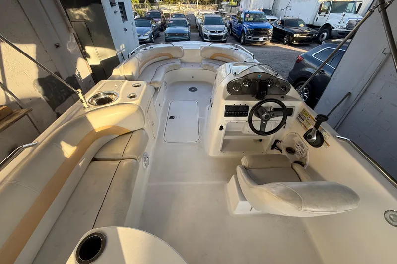 Slide: The Image of 2016 Hurricane SunDeck Sport 232 OB boat interior with seating and steering console. - 17