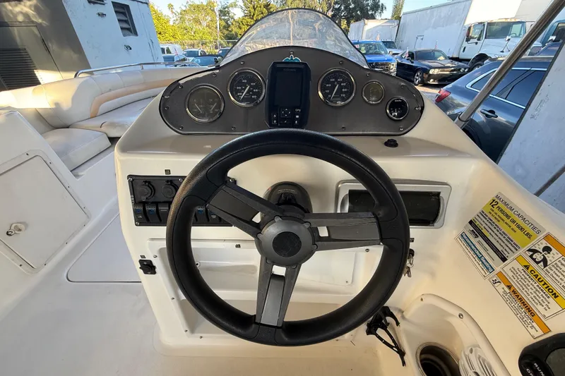 Slide: The Image of Steering console of 2016 Hurricane SunDeck Sport 232 OB boat with gauges and controls. - 21