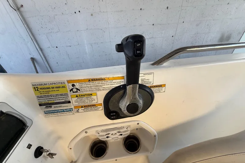 Slide: The Image of 2016 Hurricane SunDeck Sport 232 OB throttle control with capacity and safety warnings. - 22