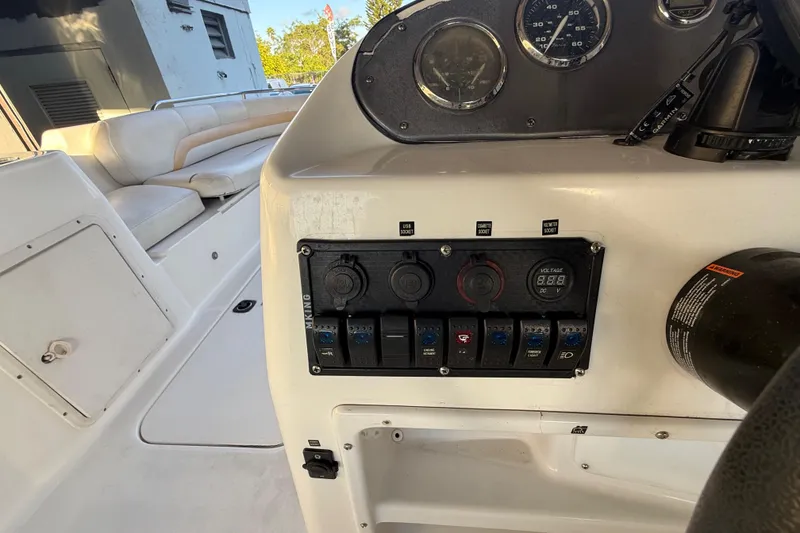 Slide: The Image of Control panel of a 2016 Hurricane SunDeck Sport 232 OB boat with seating area. - 24