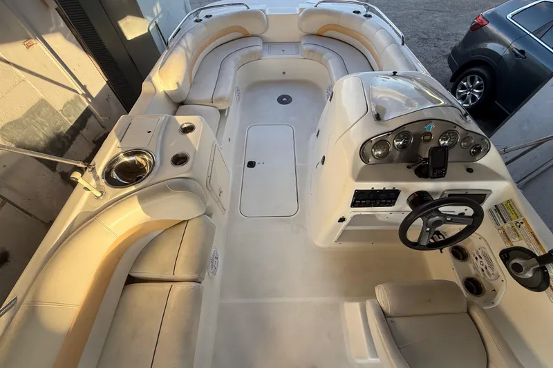Slide: The Image of 2016 Hurricane SunDeck Sport 232 OB boat interior with seating and control panel. - 25