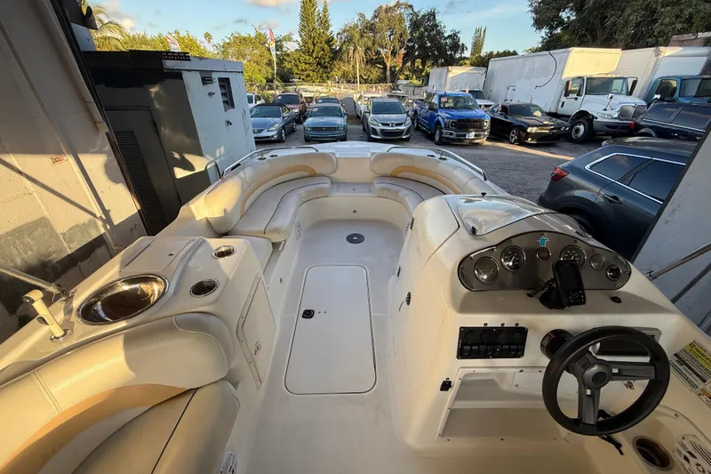 Slide: The Image of 2016 Hurricane SunDeck Sport 232 OB boat interior with seating and control panel. - 26