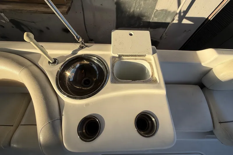 Slide: The Image of 2016 Hurricane SunDeck Sport 232 OB boat interior with sink and storage compartment. - 29