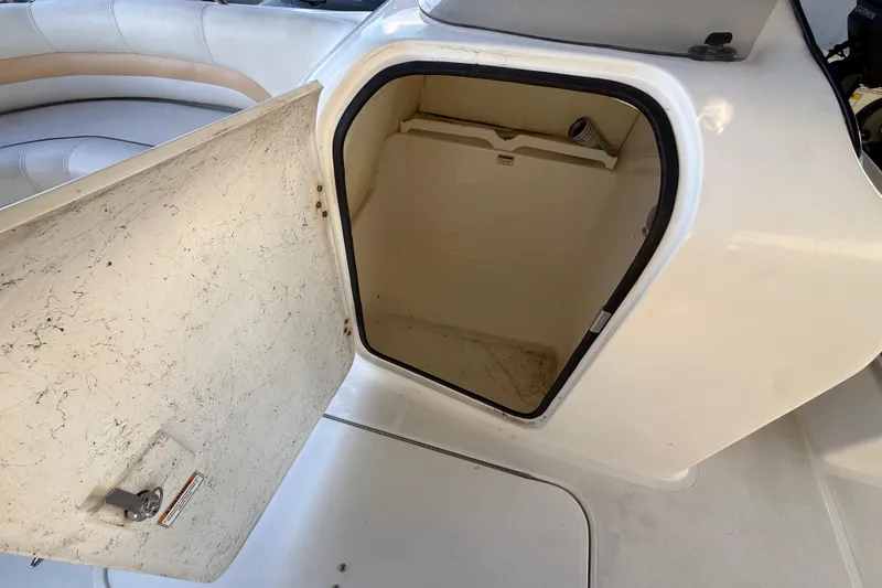 Slide: The Image of Open storage compartment on 2016 Hurricane SunDeck Sport 232 OB boat. - 32