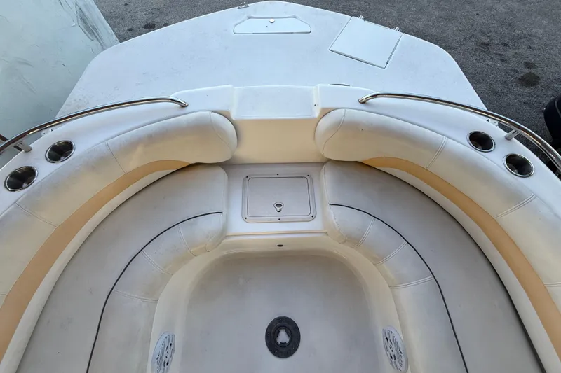 Slide: The Image of 2016 Hurricane SunDeck Sport 232 OB boat interior with cushioned seating and cup holders. - 35