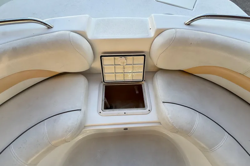 Slide: The Image of 2016 Hurricane SunDeck Sport 232 OB boat interior with storage compartment and cushioned seating. - 37