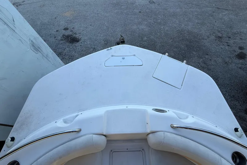 Slide: The Image of 2016 Hurricane SunDeck Sport 232 OB boat deck, white surface, outdoor setting. - 38