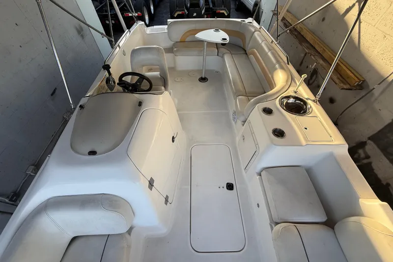 Slide: The Image of 2016 Hurricane SunDeck Sport 232 OB boat interior with seating and steering wheel. - 47