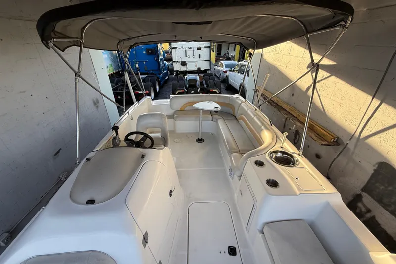 Slide: The Image of 2016 Hurricane SunDeck Sport 232 OB boat interior with seating and canopy. - 48