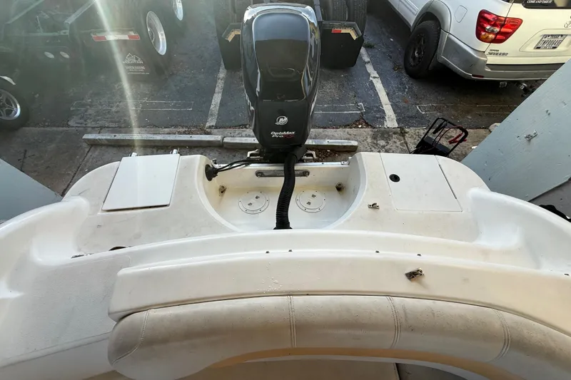 Slide: The Image of 2016 Hurricane SunDeck Sport 232 OB boat with outboard motor in parking area. - 51