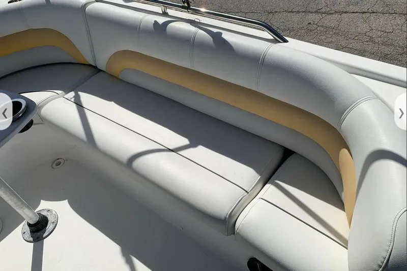 Slide: The Image of 2016 Hurricane SunDeck Sport 232 OB boat propeller on trailer, parked in concrete area. - 7