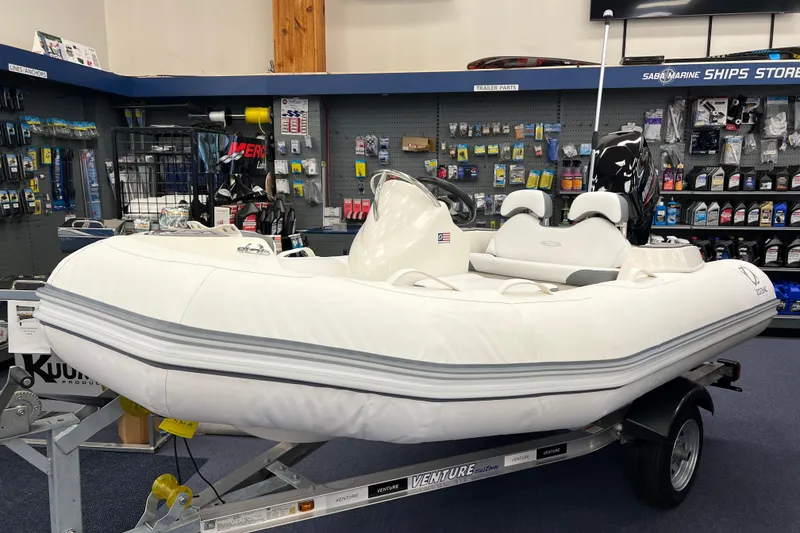 The Image of 2023 Zodiac Yachtline 360 inflatable boat displayed in a marine store. - 0