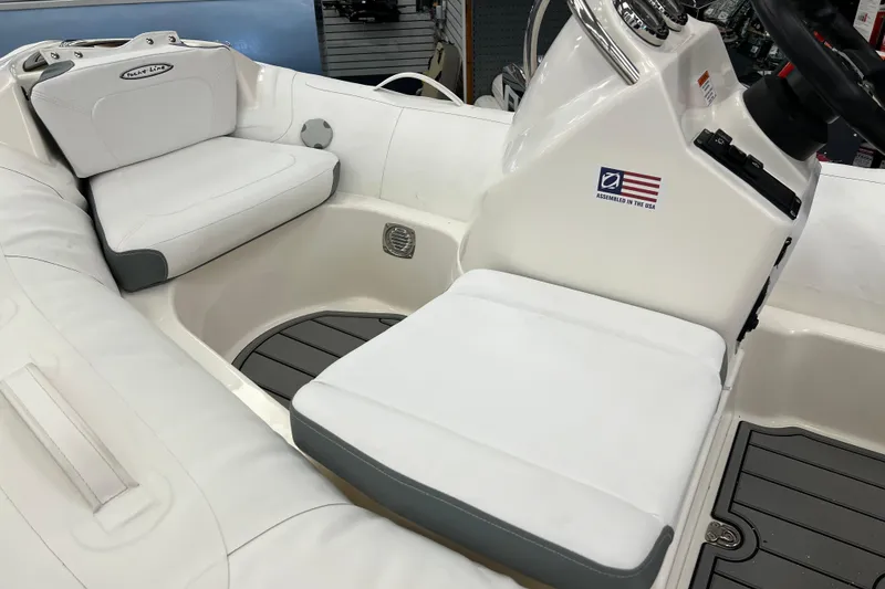 Slide: The Image of 2023 Zodiac Yachtline 360 interior with white seating and steering console. - 6