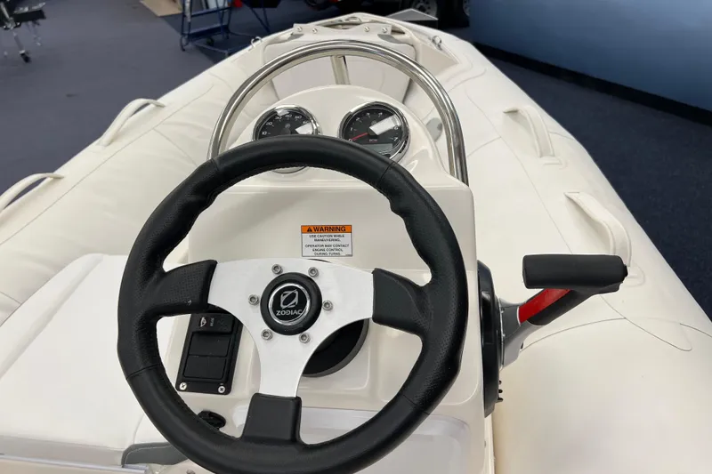 Slide: The Image of 2023 Zodiac Yachtline 360 steering console with gauges and controls. - 7