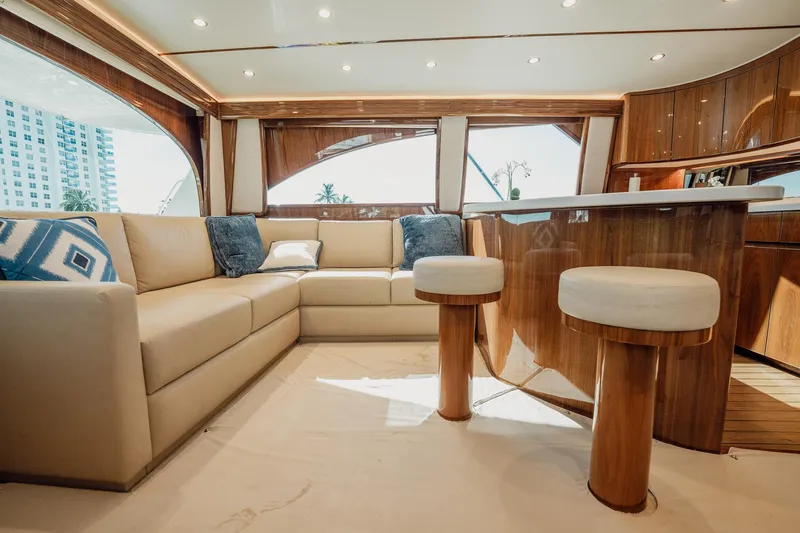 Slide: The Image of Luxurious interior of 2021 Viking 54 Convertible yacht with plush seating and elegant wood finishes. - 11