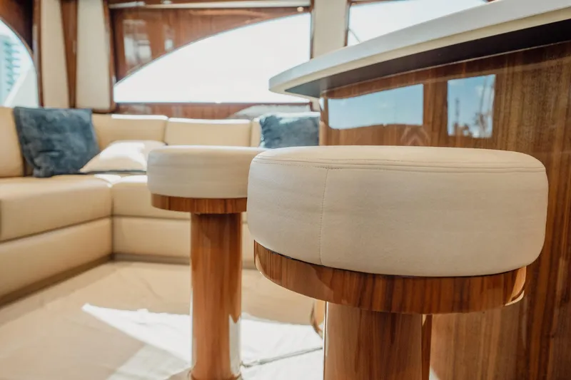 Slide: The Image of Luxurious interior of 2021 Viking 54 Convertible yacht with plush seating and wooden accents. - 12