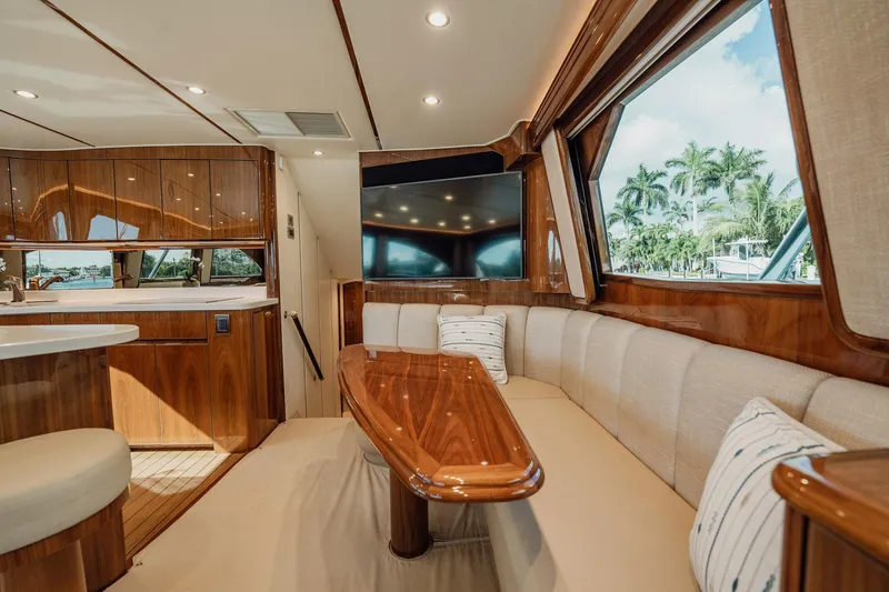 Slide: The Image of Luxurious interior of 2021 Viking 54 Convertible yacht with elegant wood finishes and plush seating. - 13