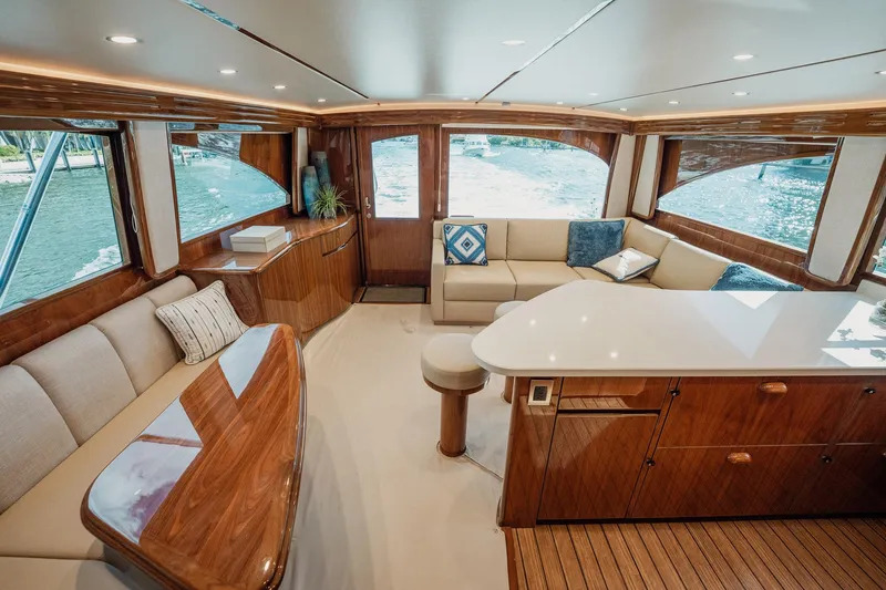 Slide: The Image of Luxurious interior of 2021 Viking 54 Convertible yacht with elegant wood finishes and plush seating. - 16