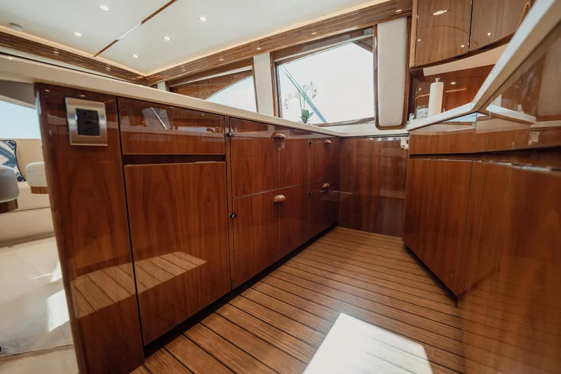 Slide: The Image of Luxurious interior of 2021 Viking 54 Convertible yacht with polished wood cabinetry. - 17