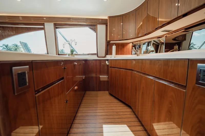 Slide: The Image of Luxurious interior of 2021 Viking 54 Convertible yacht with polished wood cabinetry. - 18