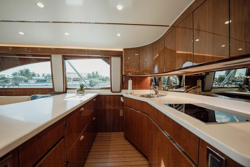 Slide: The Image of Luxurious kitchen interior of 2021 Viking 54 Convertible yacht with sleek wood cabinetry. - 19