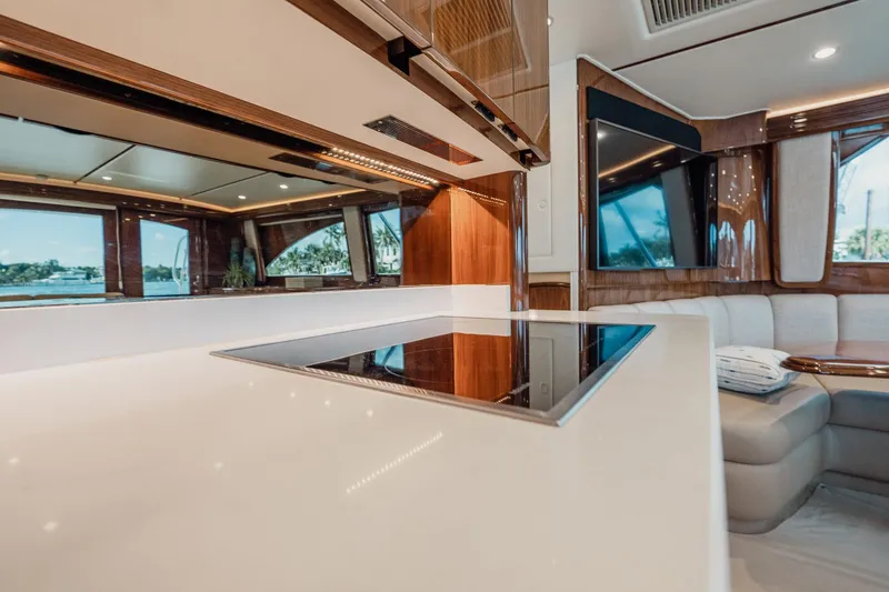 Slide: The Image of Luxurious interior of 2021 Viking 54 Convertible yacht with modern kitchen and seating area. - 21