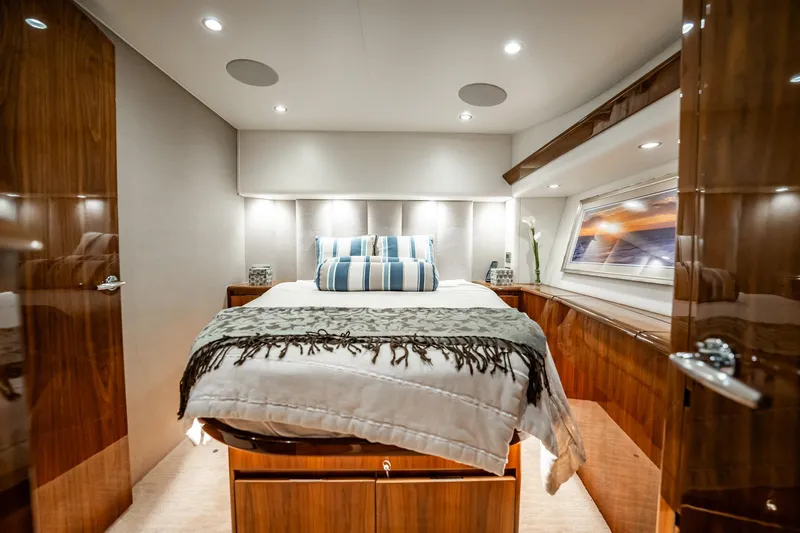 Slide: The Image of Luxurious bedroom interior of 2021 Viking 54 Convertible yacht with elegant wood finishes. - 26