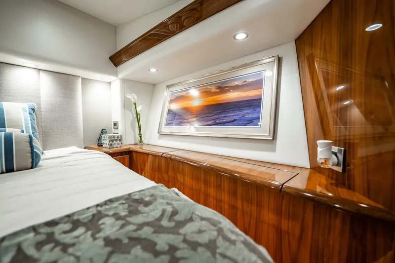 Slide: The Image of Luxurious 2021 Viking 54 Convertible yacht bedroom with elegant wood finish and ocean artwork. - 29