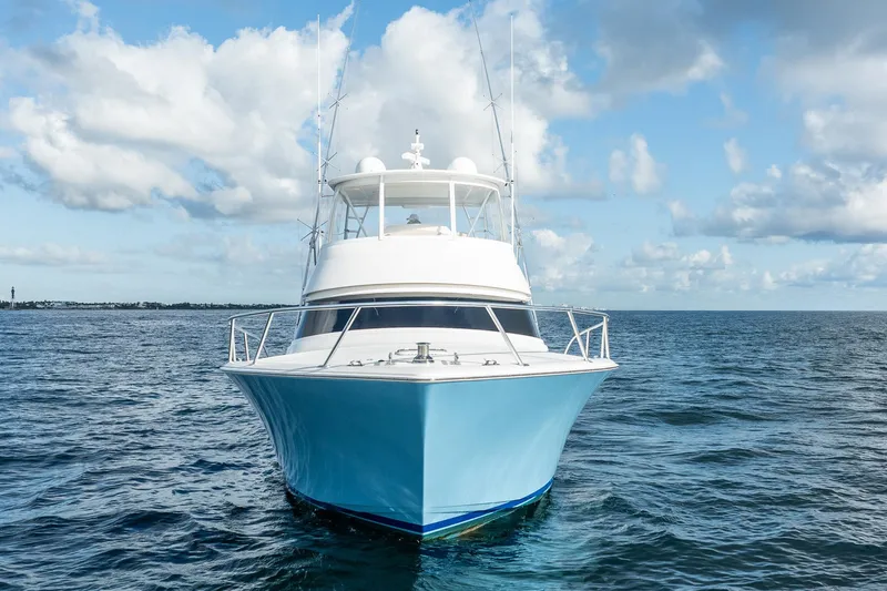 Slide: The Image of 2021 Viking 54 Convertible yacht on open sea under blue sky. - 3