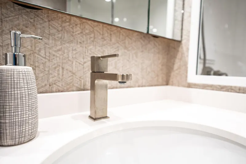 Slide: The Image of Modern bathroom sink with sleek faucet and textured soap dispenser on Viking 54 Convertible yacht. - 34