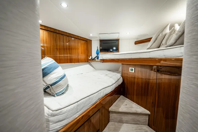 Slide: The Image of Luxurious cabin interior of 2021 Viking 54 Convertible yacht with wooden finishes. - 37