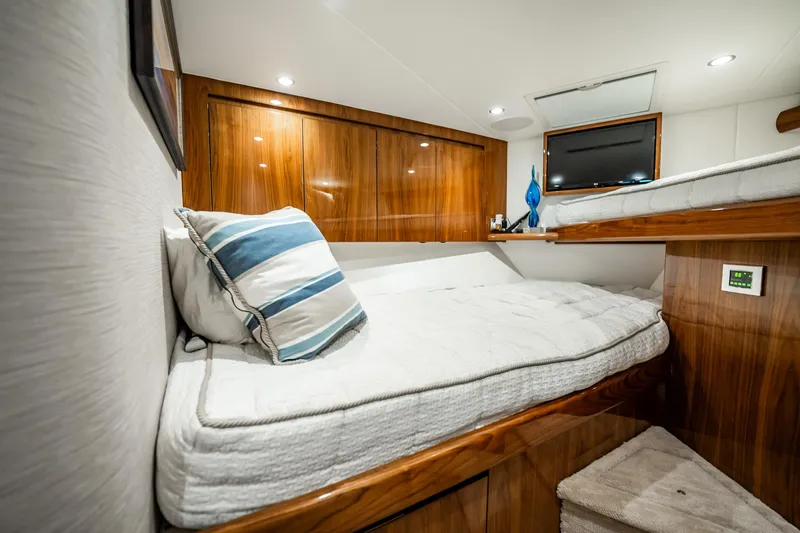 Slide: The Image of Luxurious cabin interior of 2021 Viking 54 Convertible yacht with wooden finishes. - 38