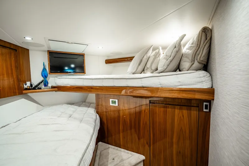 Slide: The Image of Luxurious cabin interior of 2021 Viking 54 Convertible yacht with cozy bedding. - 39