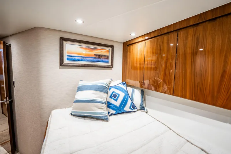 Slide: The Image of Luxurious cabin interior of 2021 Viking 54 Convertible yacht with elegant wood finishes. - 40