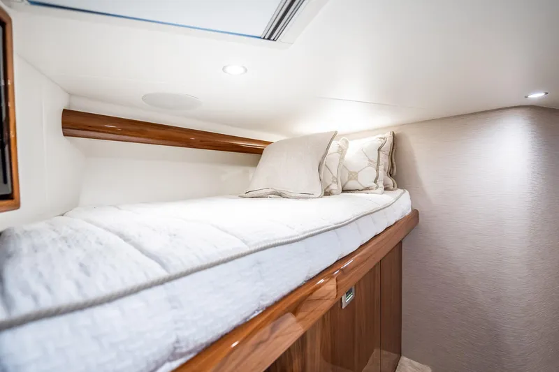 Slide: The Image of Luxurious cabin interior of 2021 Viking 54 Convertible yacht with cozy bedding. - 41