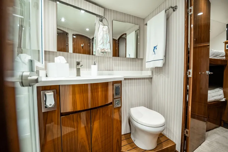Slide: The Image of Luxurious bathroom in 2021 Viking 54 Convertible yacht with modern fixtures and elegant wood finishes. - 43