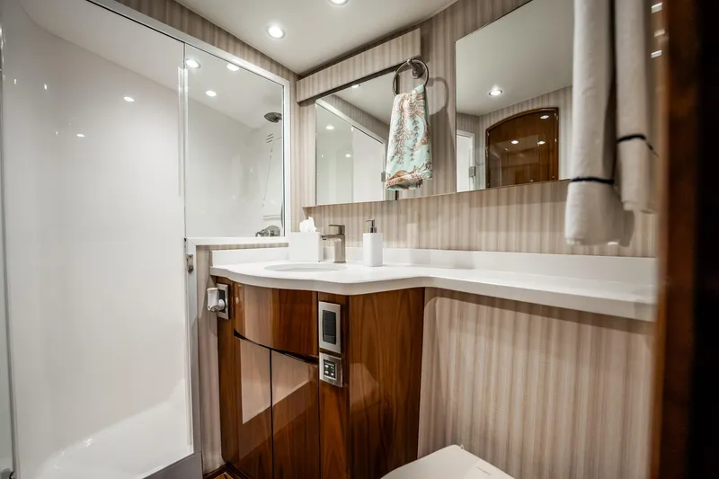 Slide: The Image of Luxurious bathroom interior of 2021 Viking 54 Convertible yacht, featuring modern fixtures and elegant design. - 44