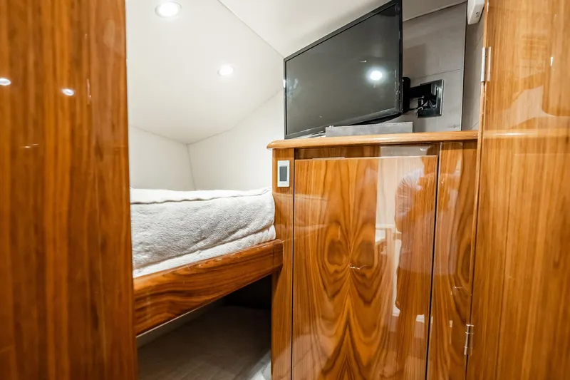 Slide: The Image of Luxurious cabin interior of 2021 Viking 54 Convertible yacht with wood finish and TV. - 47