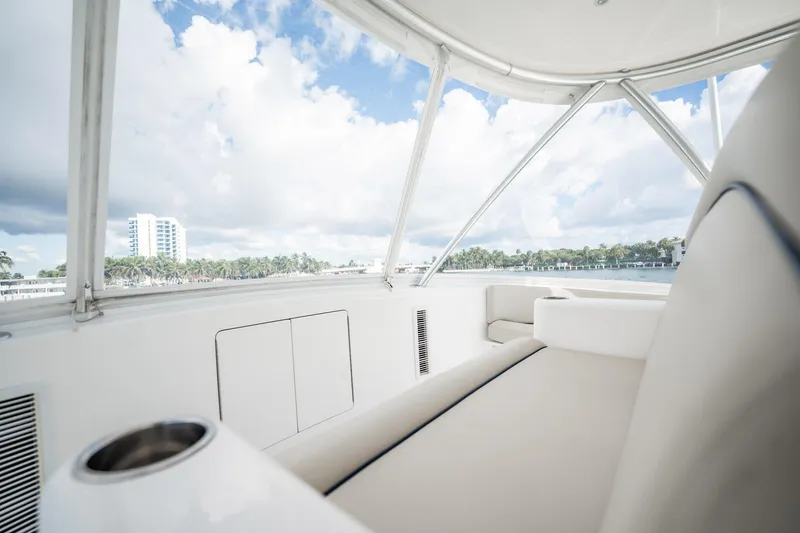 Slide: The Image of 2021 Viking 54 Convertible yacht interior with ocean view and modern seating. - 52