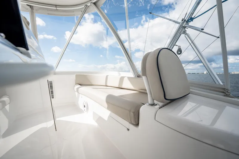 Slide: The Image of Interior of 2021 Viking 54 Convertible yacht with ocean view and plush seating. - 56