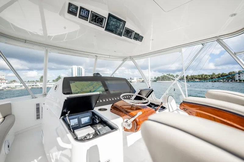 Slide: The Image of Luxurious helm of 2021 Viking 54 Convertible yacht with advanced navigation systems. - 58