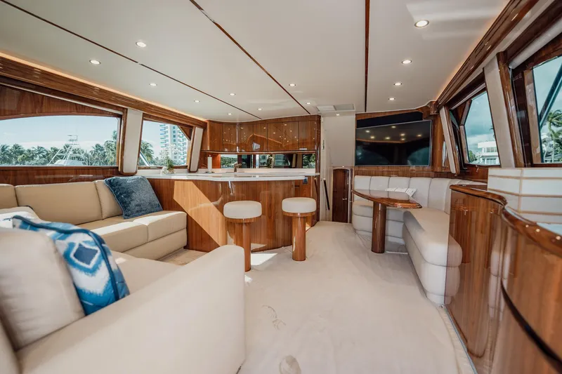 Slide: The Image of Luxurious interior of 2021 Viking 54 Convertible yacht with elegant wood finishes and plush seating. - 6