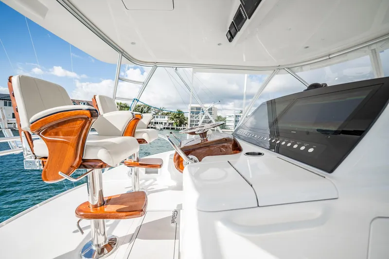 Slide: The Image of Luxurious helm of 2021 Viking 54 Convertible yacht with modern controls and seating. - 66