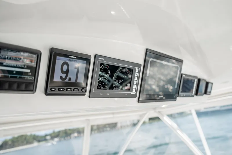 Slide: The Image of Dashboard of 2021 Viking 54 Convertible yacht with navigation displays. - 67
